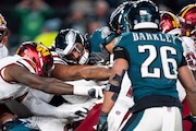 Eagles quarterback Jalen Hurts (1) tries to Tush Push as the Washington Commanders defensive stops him during the NFC championship game.