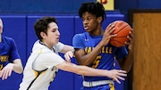 Shawn Purcell (5) of Manville looks to pass as Frankie Denvir (3) of Delaware Valley defends during the boys basketball game between Delaware Valley and Manville at Delaware Valley High School in Frenchtown, NJ on Thursday, January 6, 2022. 