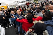 Ice agents surround U.S. Rep LaMonica McIver (red jacket), U.S. Rep Bonnie Coleman (tan jacket) , and Newark Mayor Ras Baraka outside Delaney Hall in Newark on Friday, May 9, 2025.