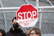 A protester holds up a sign outside Delaney Hall in Newark on Friday, May 9, 2025.