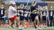 Tyler Hanson of Westwood (left) stick-checks Owen Crowley of Ramsey (34) in Saturday's high school boys lacrosse shootout in Ramsey.  The Rams grounded the Cardinals, 8-3. 04/05/2025